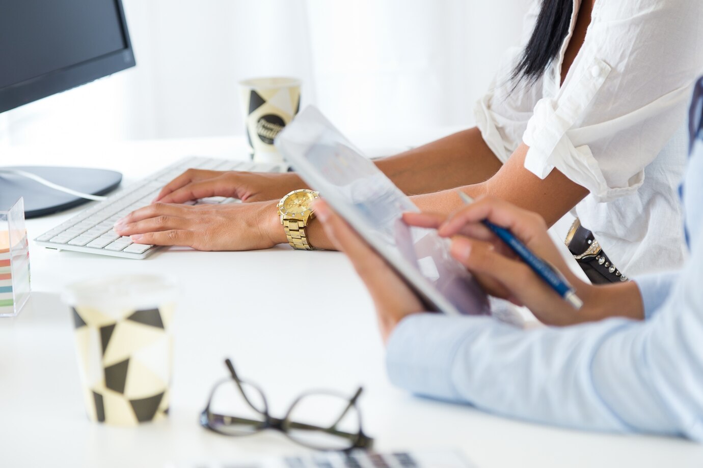 two-business-woman-working-office-with-digital-tablet_1301-3521